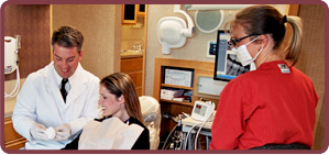 Superior dentist with adult patient