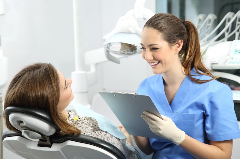 adult patient at dental appointment speaking to dentist 